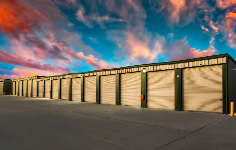 Bee Cave Secure Storage Units – Small Business Inventory Solutions Secure storage units in Bee Cave, TX with roll-up doors at sunset, ideal for small business inventory storage.
